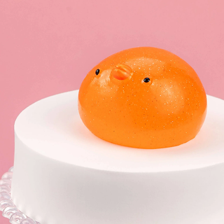Glittery orange penguin squishy.
