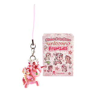 Haru & Harumi charm featuring a shiny pink Unicorno wearing a white crown with a cream colored smaller Unicorno riding on its back with cherry blossoms in its mane. The blind box packaging is in the background.