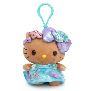 Tan Hello Kitty wearing blue summer dress with shiny bows and sea shells with a blue bag clip